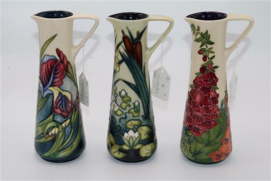 Three Moorcroft cylindrical ewers in Limia, Iris and Foxglove patterns, 1995-2002, height 24cm